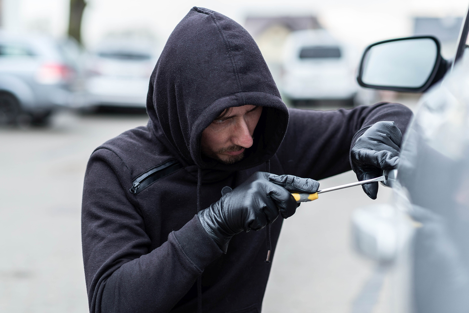 Thief Breaking Into a Car With Intent to Steal